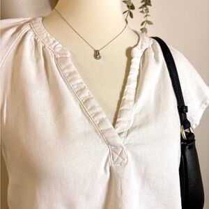 White V-Neck Blouse with Black Shoulder Bag